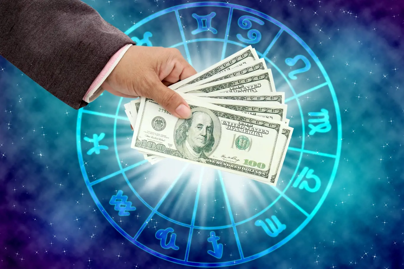 hand holding money on the horoscope concept.