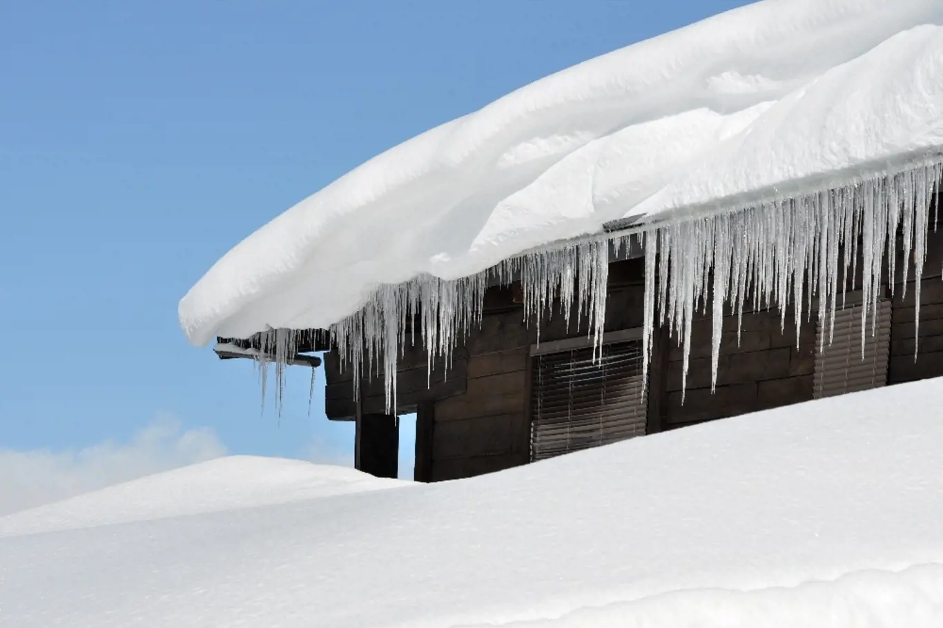 Sníh a rampouchy mohou vážně poškodit střechy.