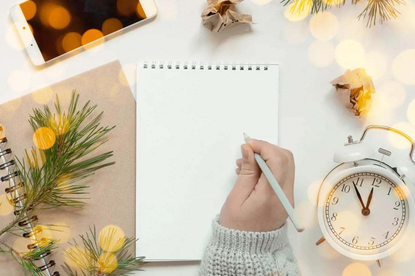 Back to life, goal list concept. Woman's hand writing in empty notebook. Resolutions, plan, goals, checklist, idea concept. Top view, flat lay, copy space. 2024. Christmas, New Year.