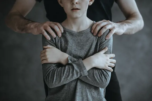Pedophile and young boy as a victim of abuse