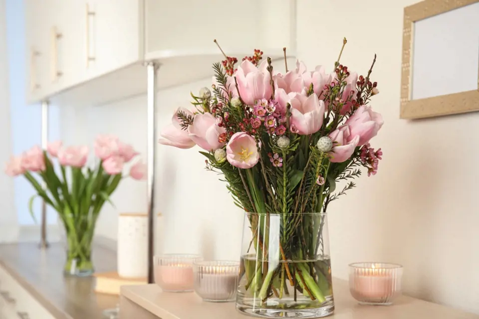 Pastelově růžové tulipány na bílé kuchyňské lince vypadají nádherně.