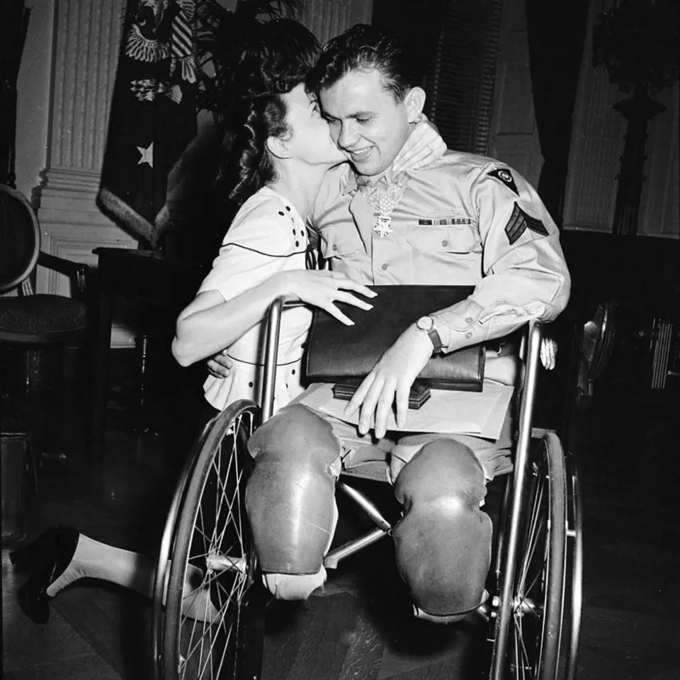 7. Jean Moore klečí a objímá svého snoubence, veterána 2. světové války, Ralpha Neppela, který byl vyznamenán Řádem cti a Purpurovým srdcem, 1945